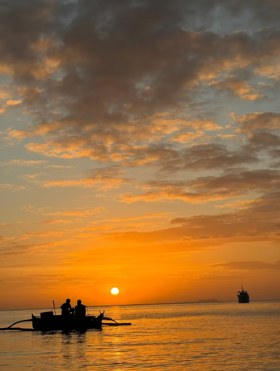 Bangka boat silhouetted against a Siquijor sunset