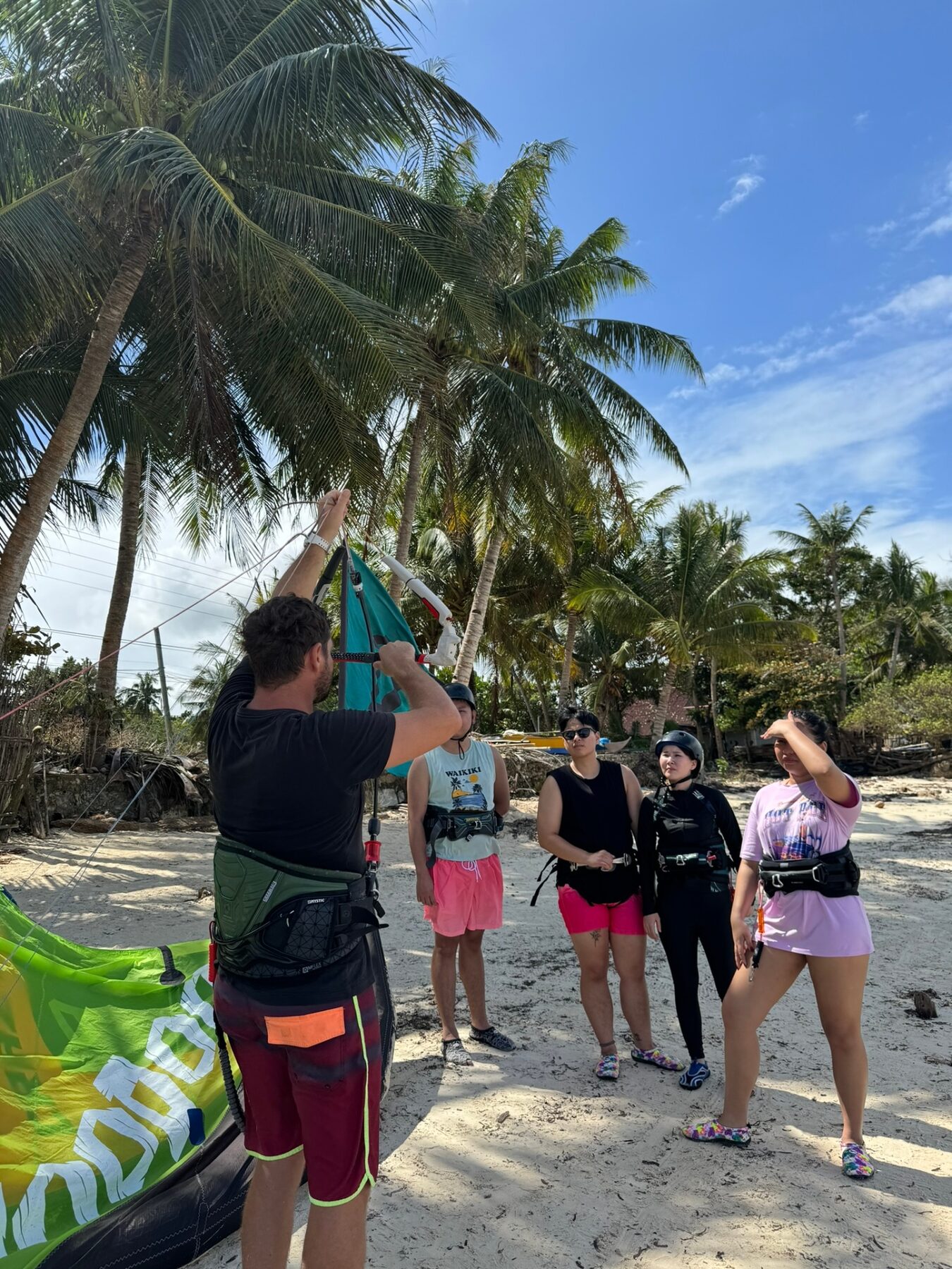 Surf Zone instructor briefing students under the palms