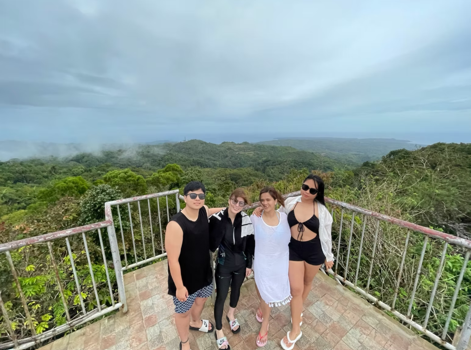 Group at a Mount Bandilan viewpoint overlooking the island