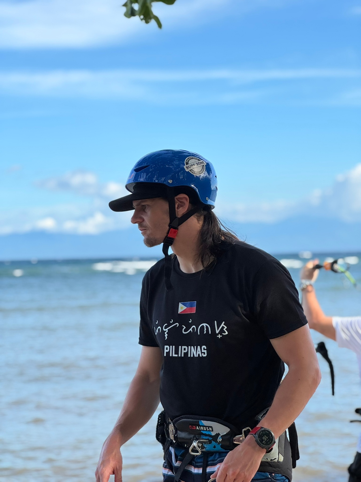 Surf Zone founder in a Pilipinas tee with helmet on the beach