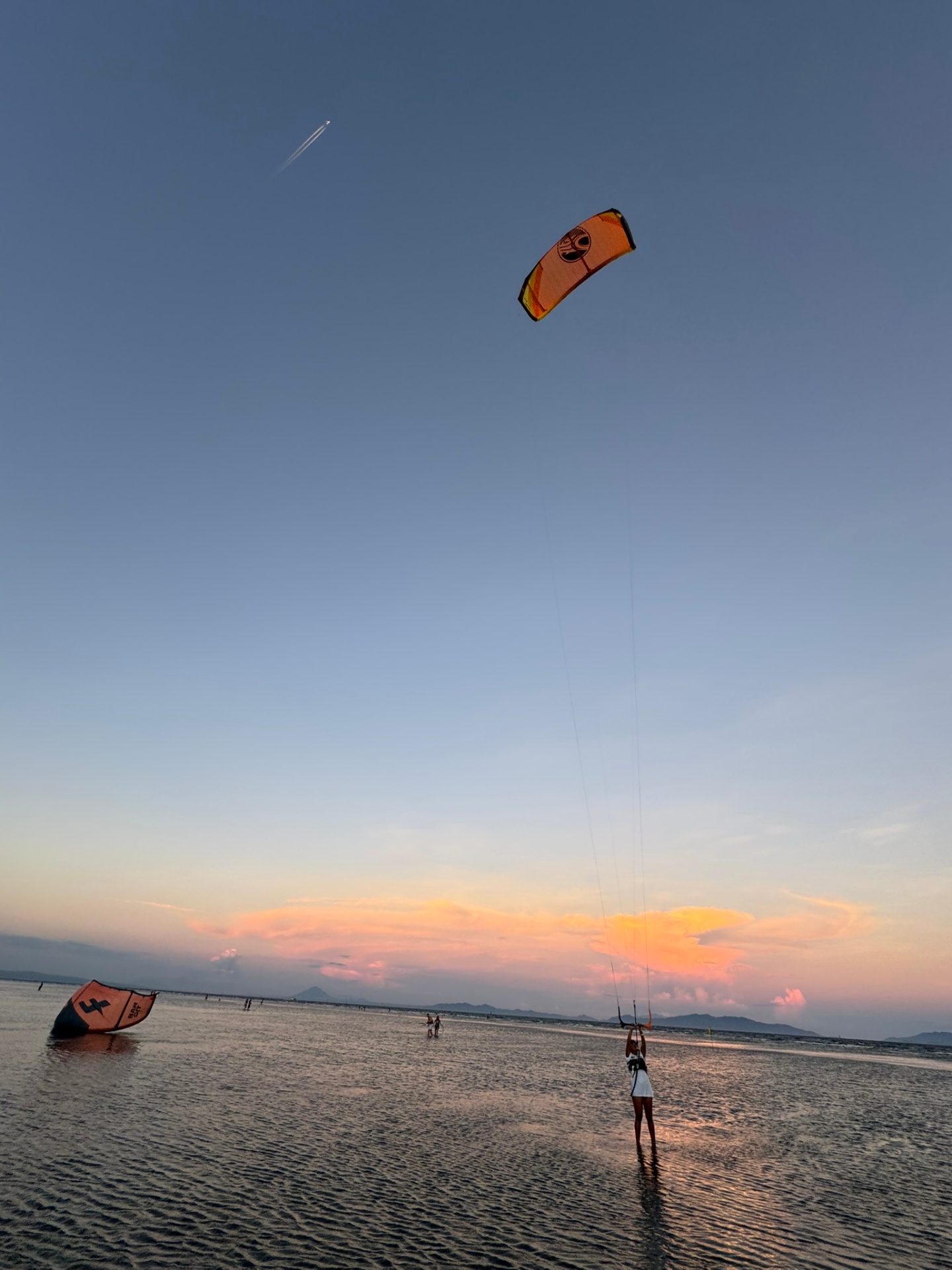 Kitesurfer at sunset in shallow water in the Philippines